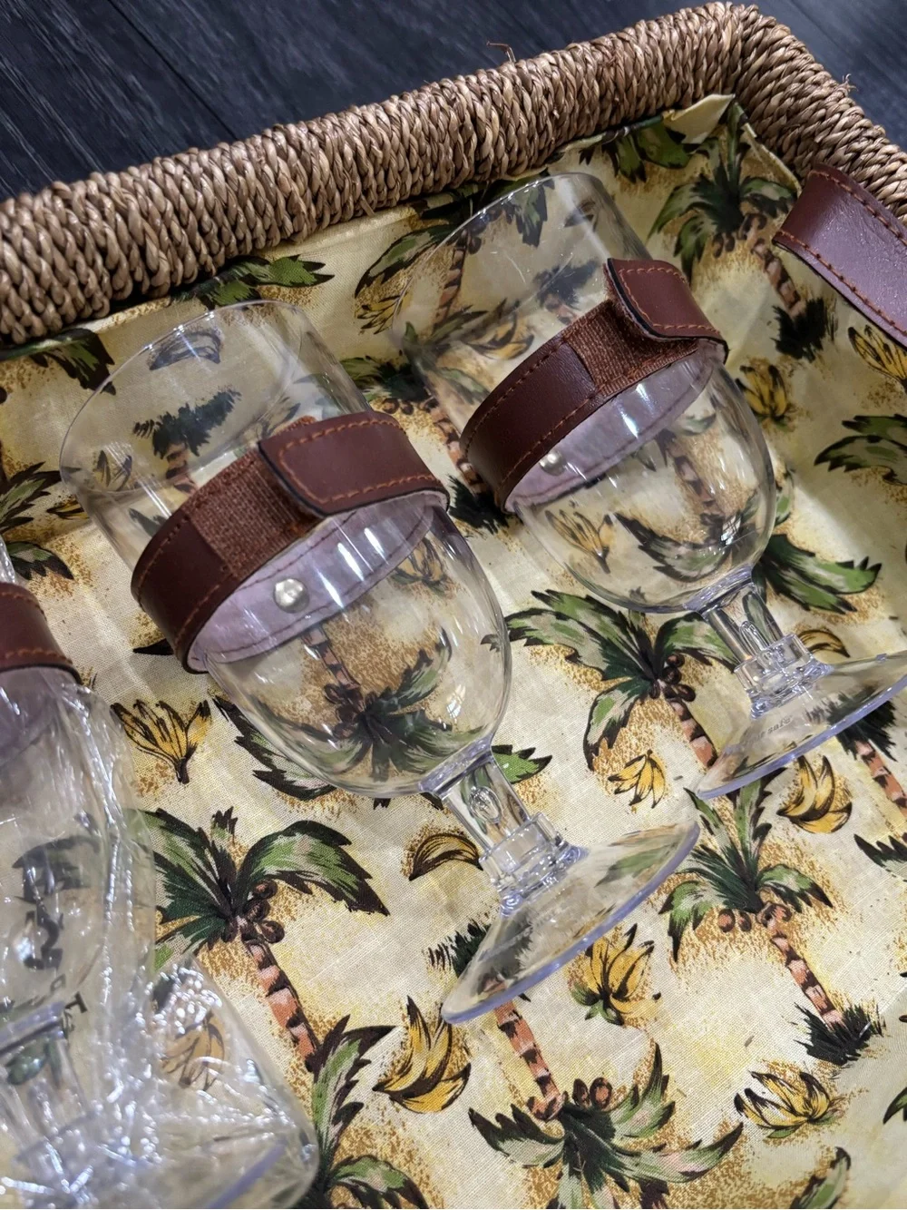 Vintage wicker and tropical palm green picnic basket service for four